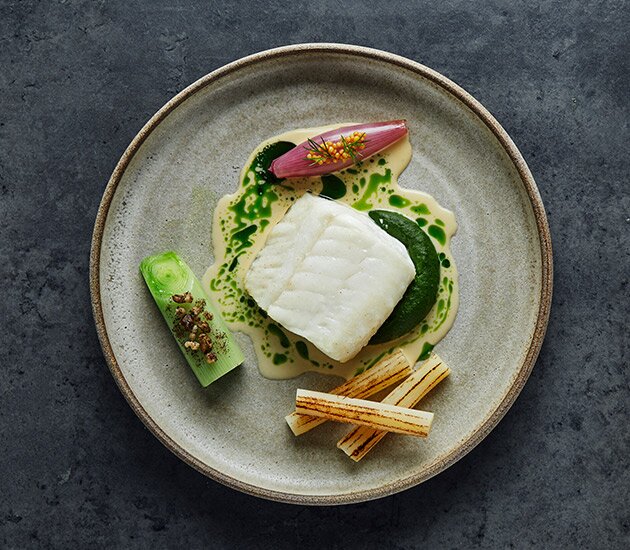 Baked Norwegian cod with vegetables and a creamy blue mussel sauce