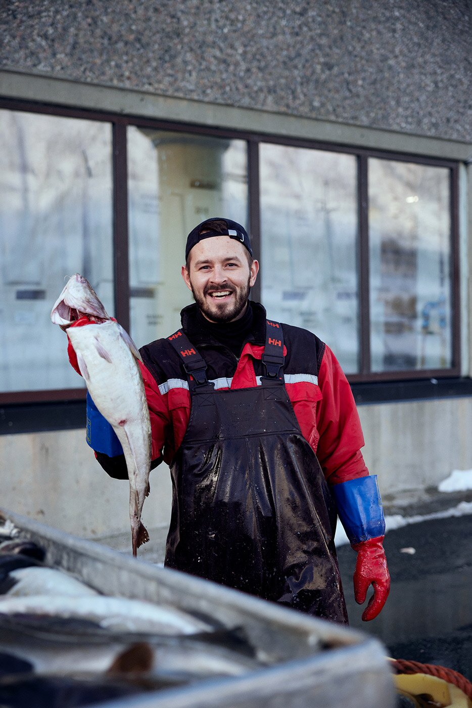 Fisherman holding up a cod