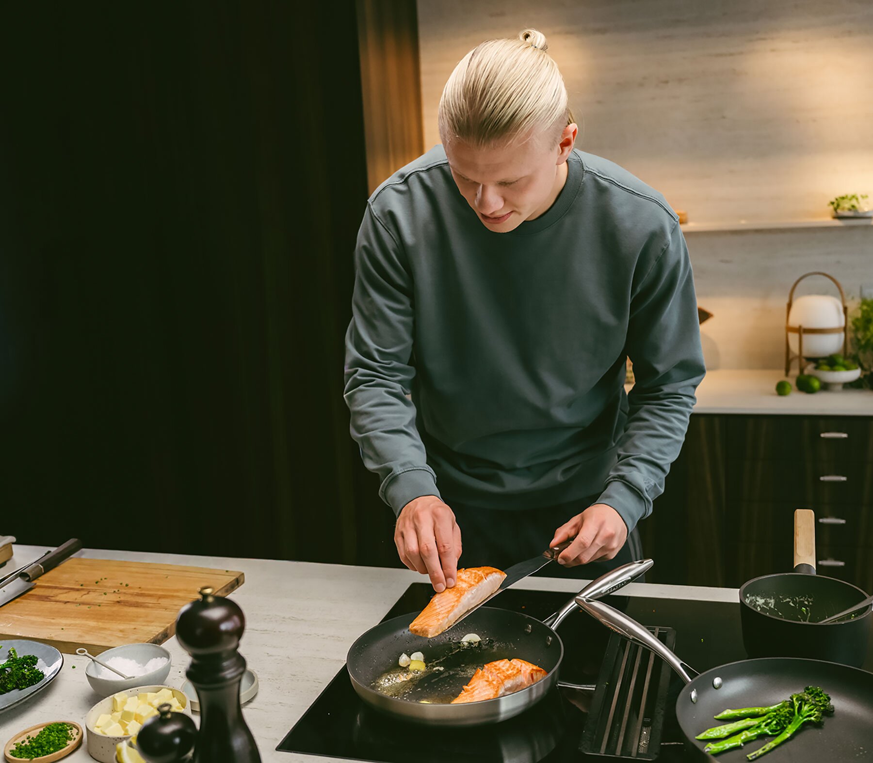 Erling Haaland in the kitchen cooking salmon