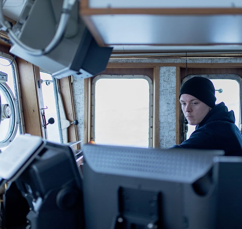 Fisherman in steeringhouse