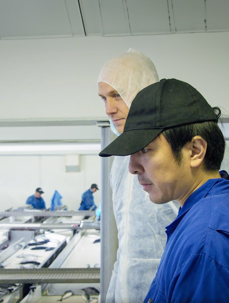 Ken Abe and worker looking at the factory floor